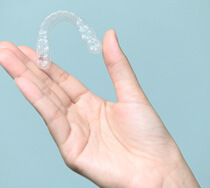 patient holding clear aligners
